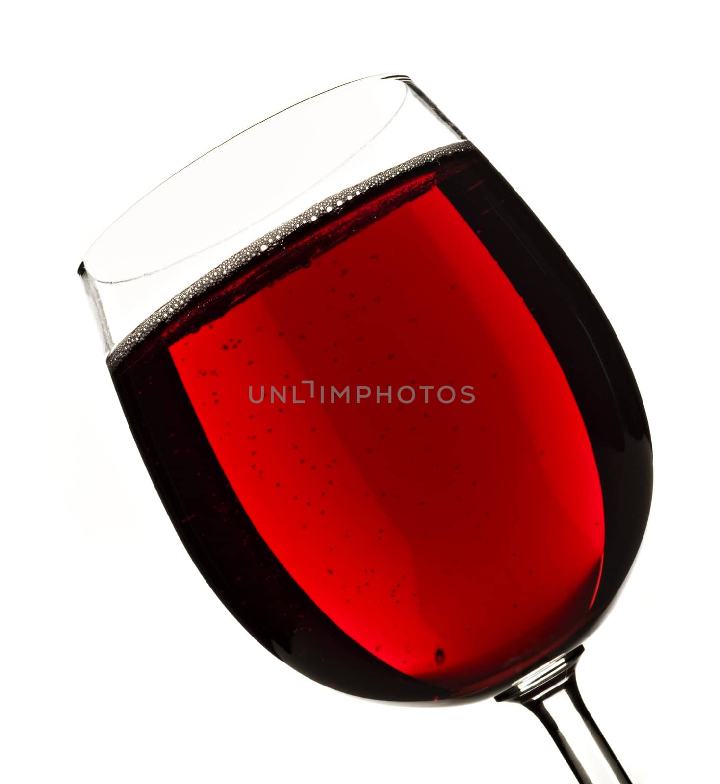 Wine glass with red fruit juice on a white background with space for text