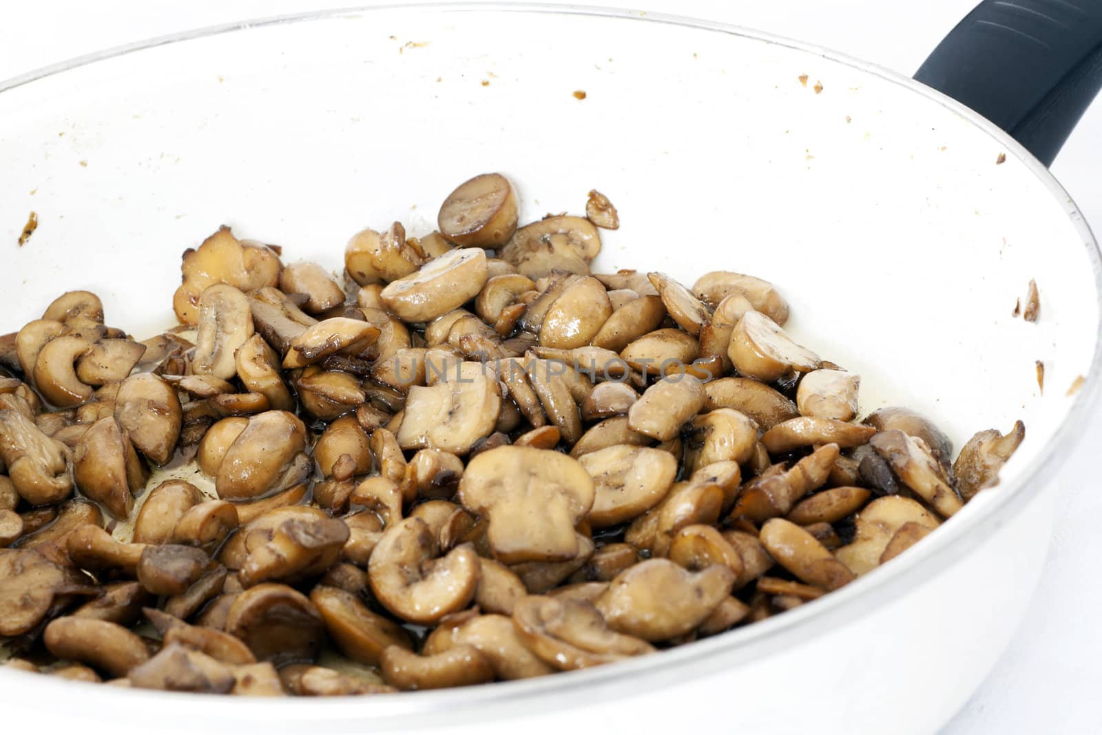 Fried mushrooms in pan by magraphics