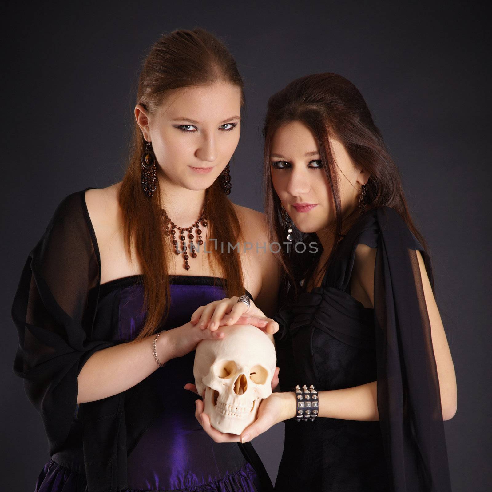Two young girls with a human skull by pzaxe