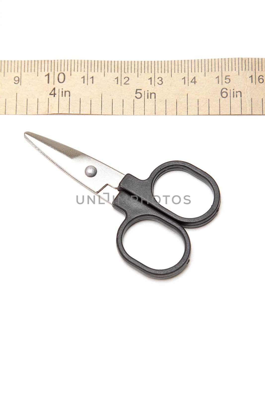 Paper measuring tape and scissors over white background