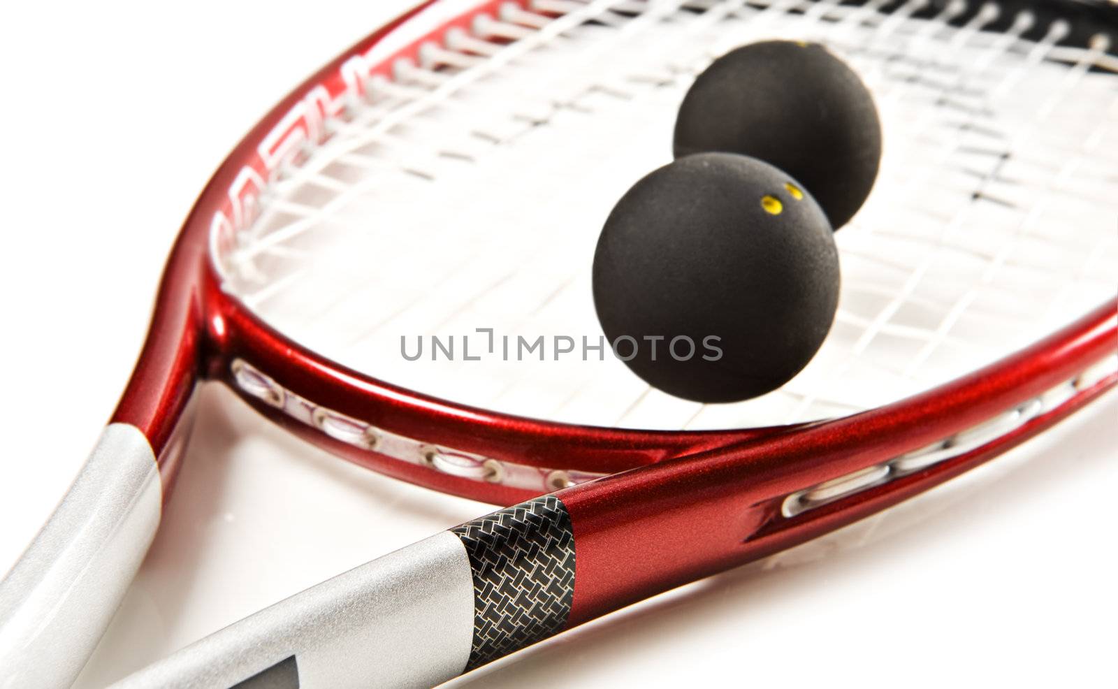 Close up of a red and silver squash racket and ball on a white background with space for text by tish1
