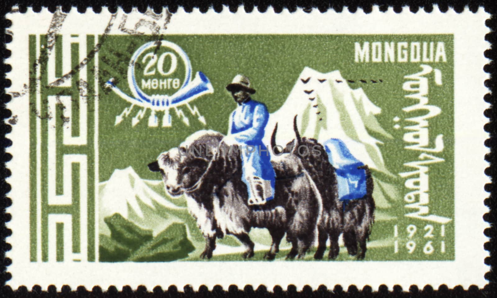 Post stamp with man in national Mongolian costume on yak by wander