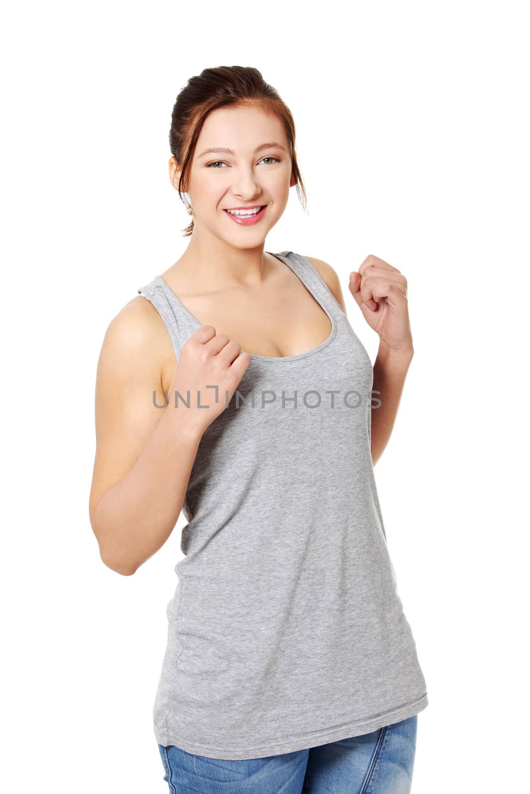 Young caucasian girl standing and smiling. Isolated on white.