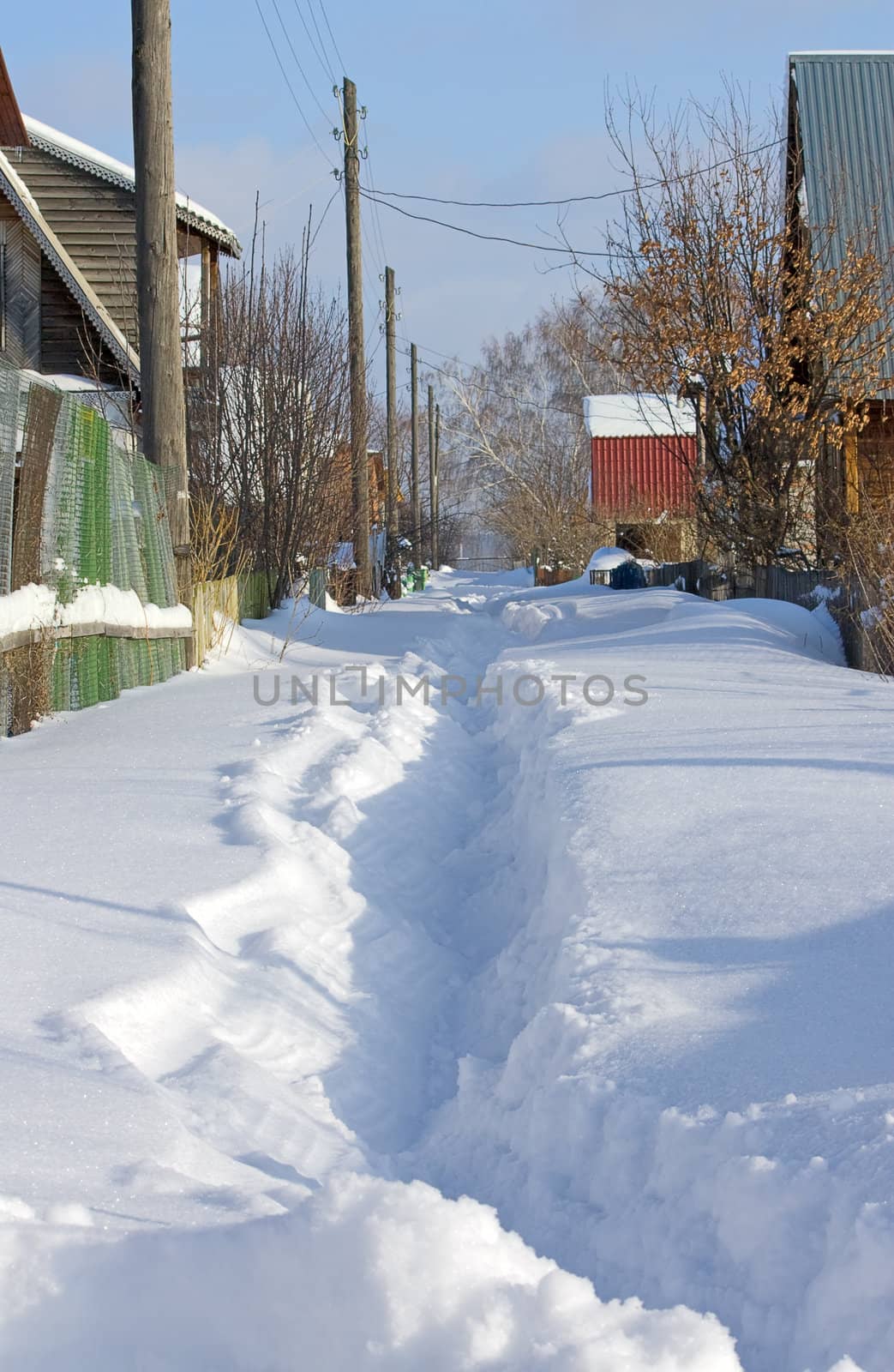 Path to  house through  drifts. Winter landscape.