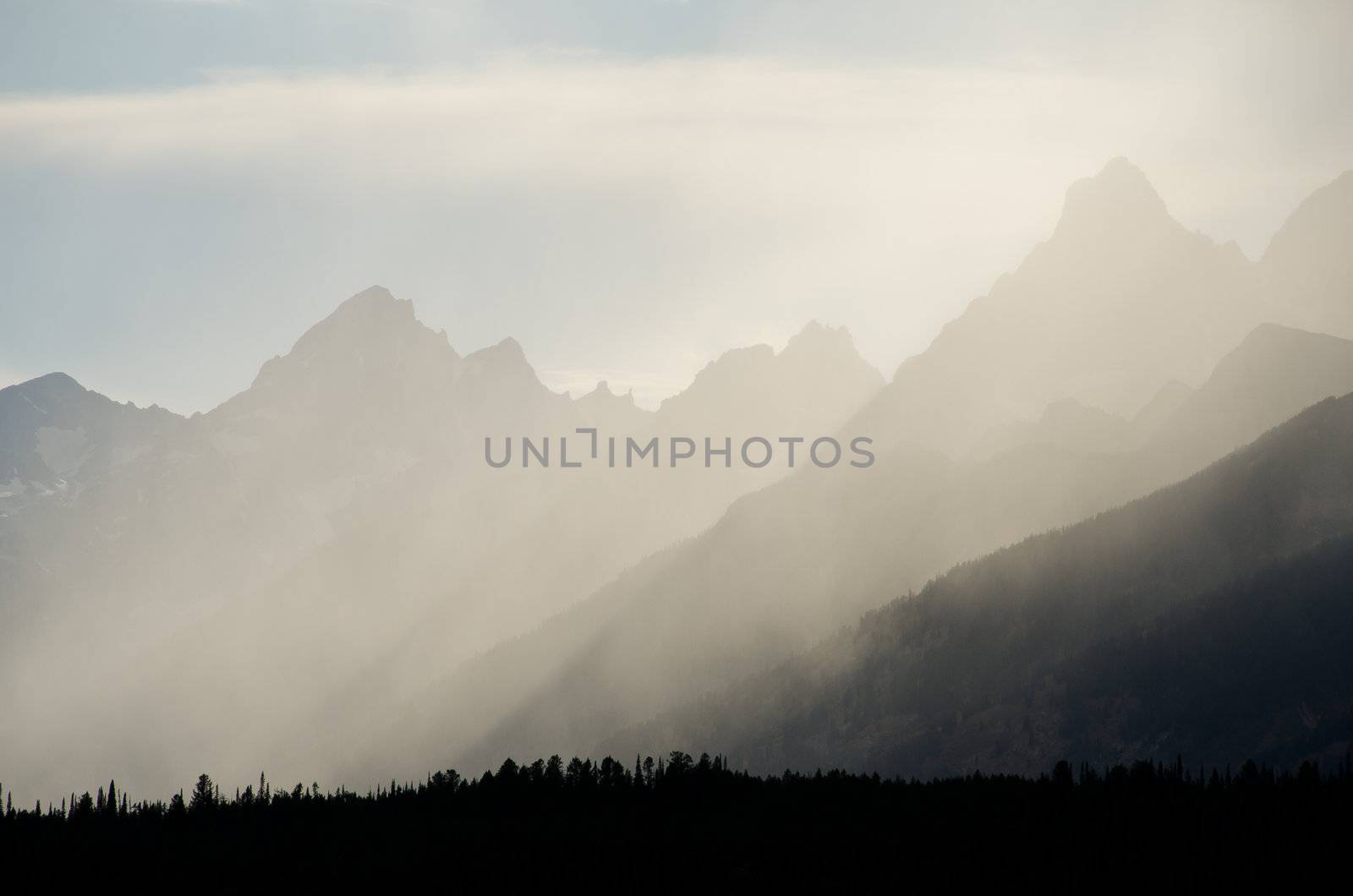 Rays of light breaking through storm clouds above the Teton Mountains, Grand Teton National Park, Wyoming, USA by CharlesBolin