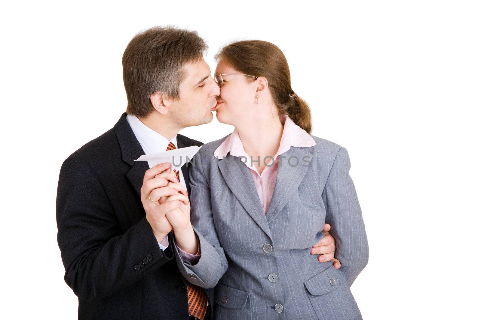 business man and woman kiss with paper airplane in hands