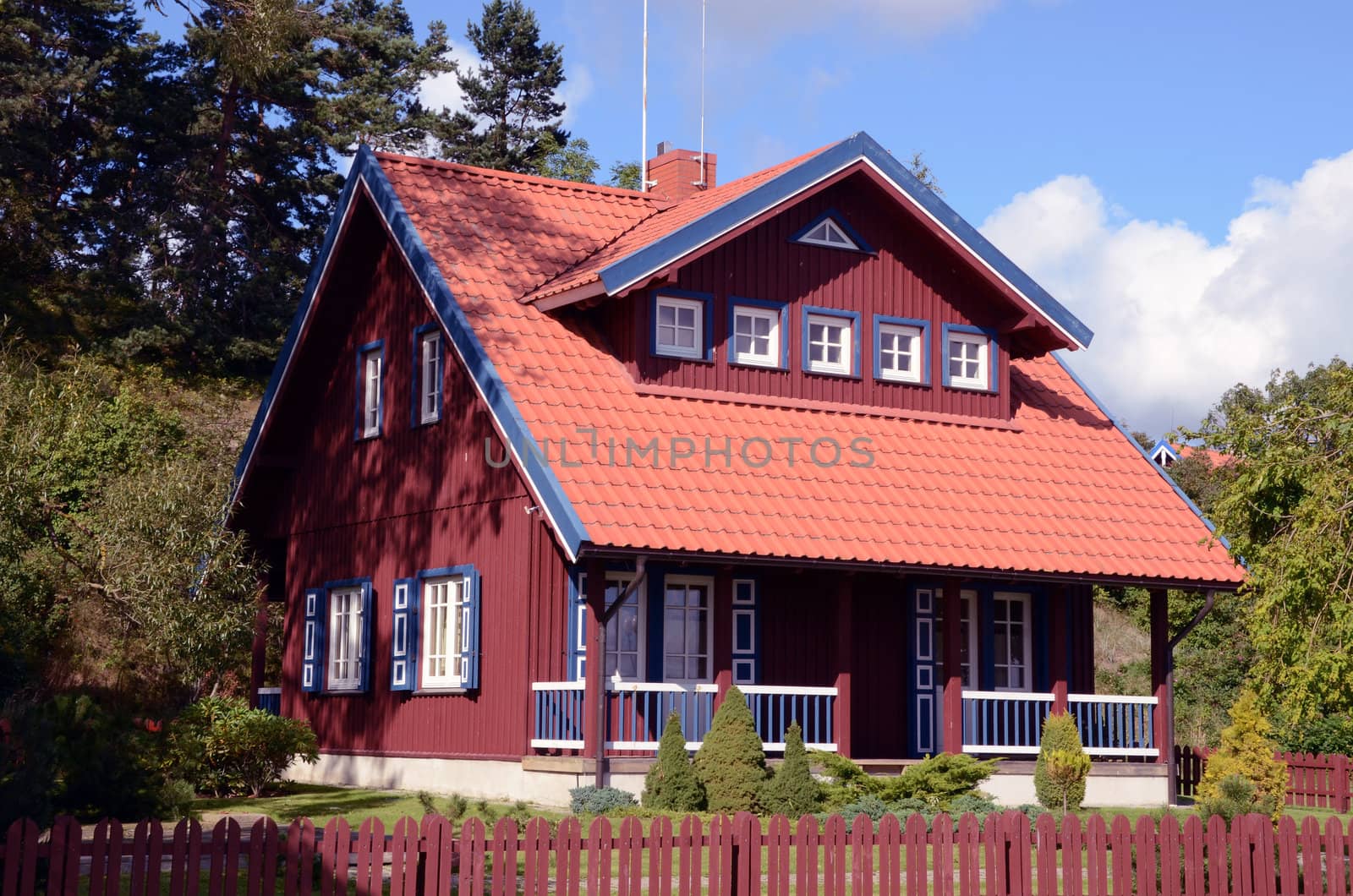 Living house. Red blue painted house. Beautiful architectural solutions.