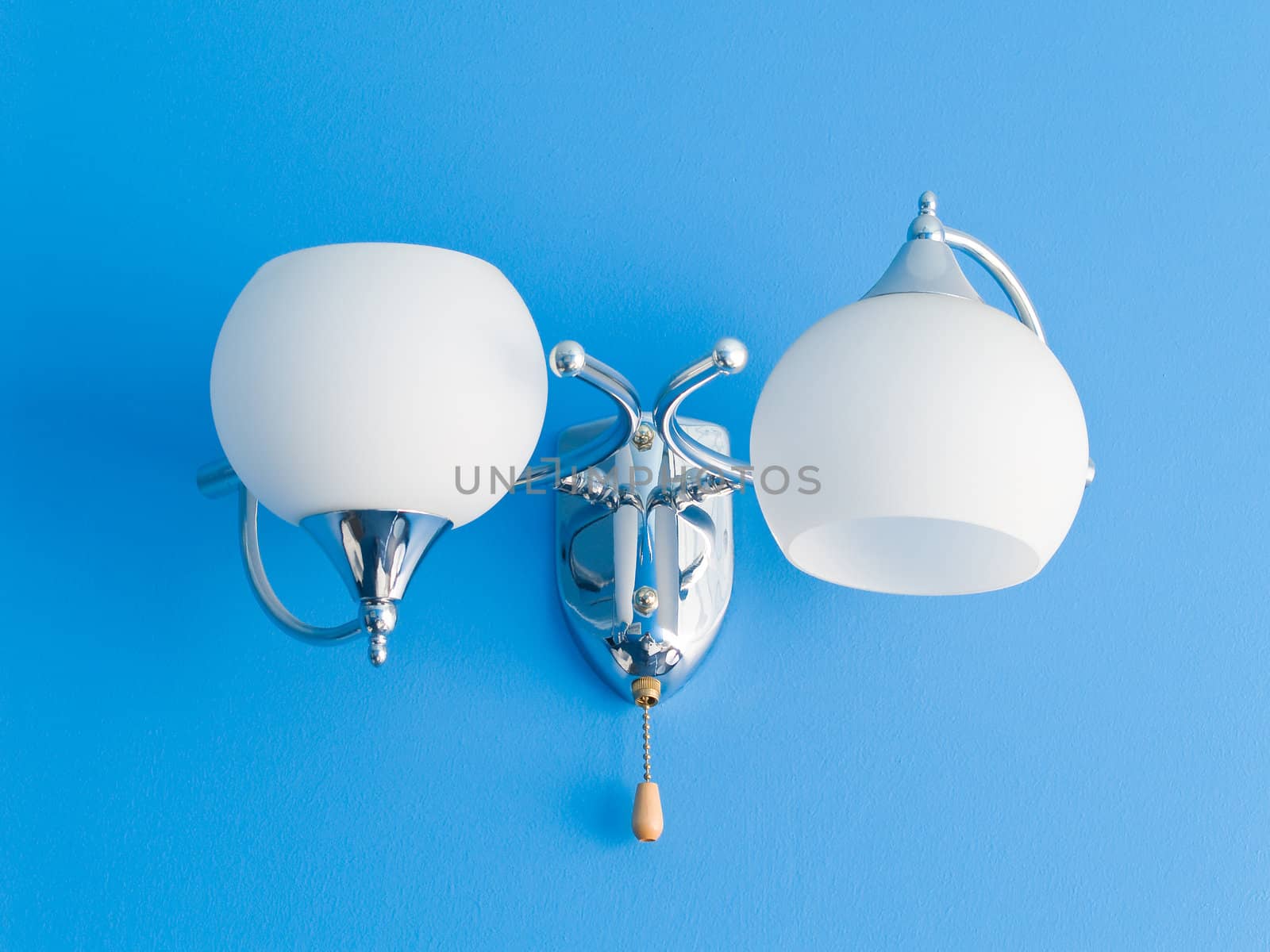 White lamp on blue texturized wall