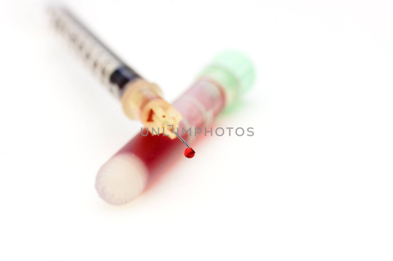 a blood droplet on a syringe needle after extraxting a sample for testing