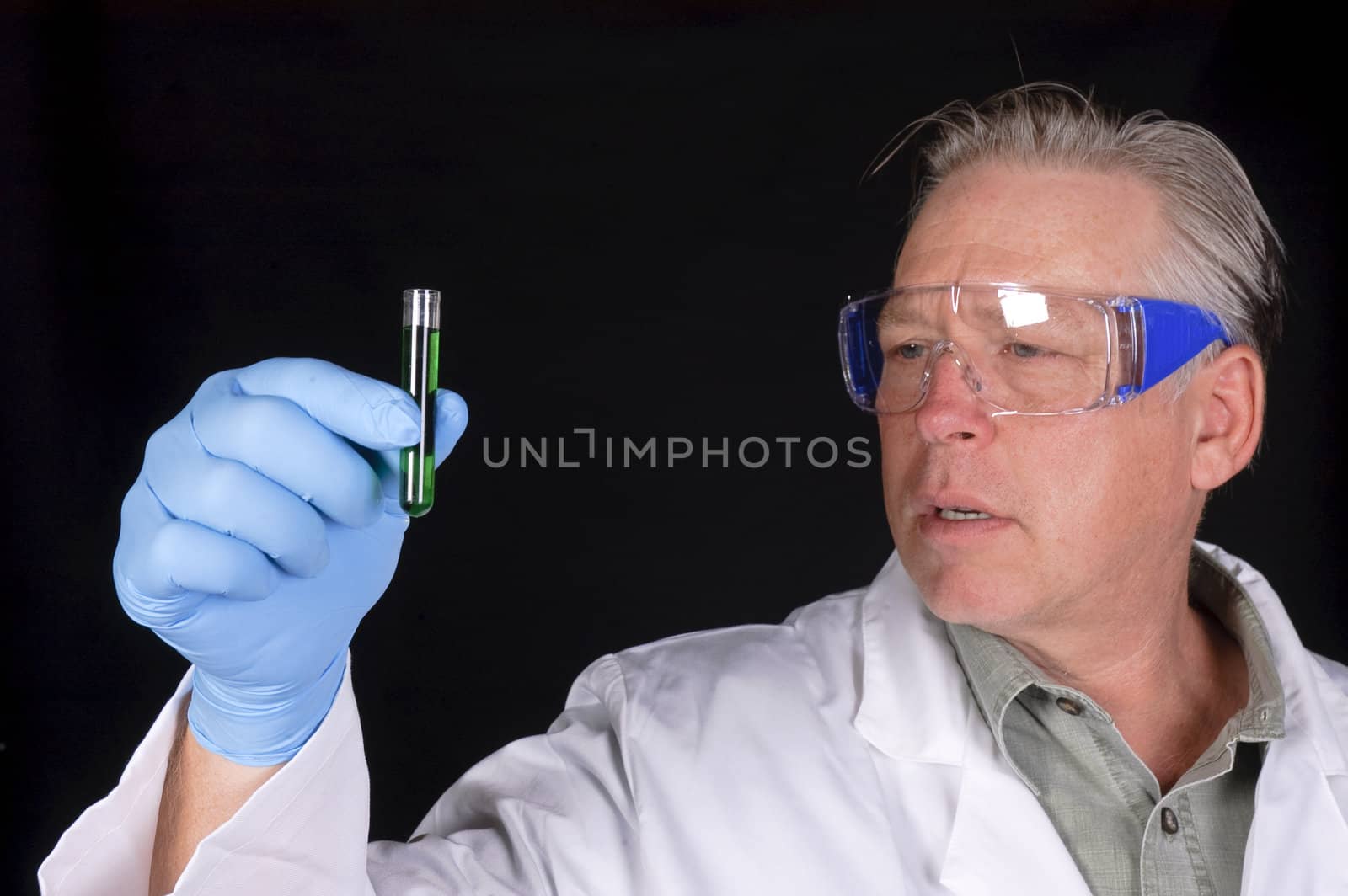 chemical engineer, doctor or research scientist looking at a sample of a chemical from a test tube