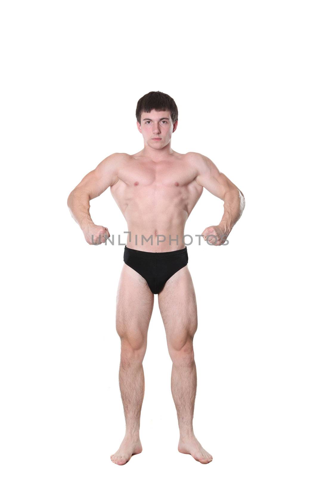 The young athlete the man poses on a white background