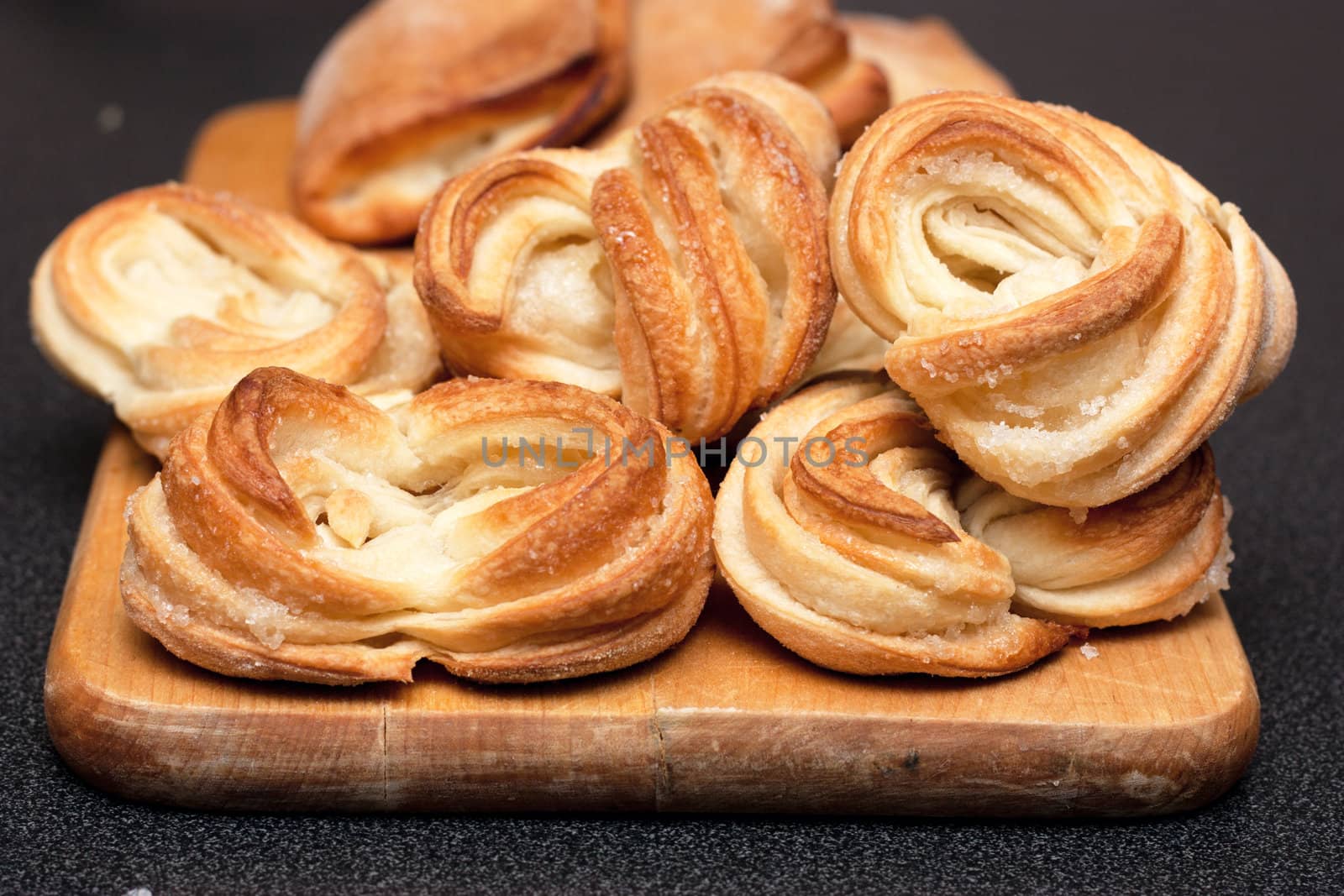 A heap of pastries on a wood board