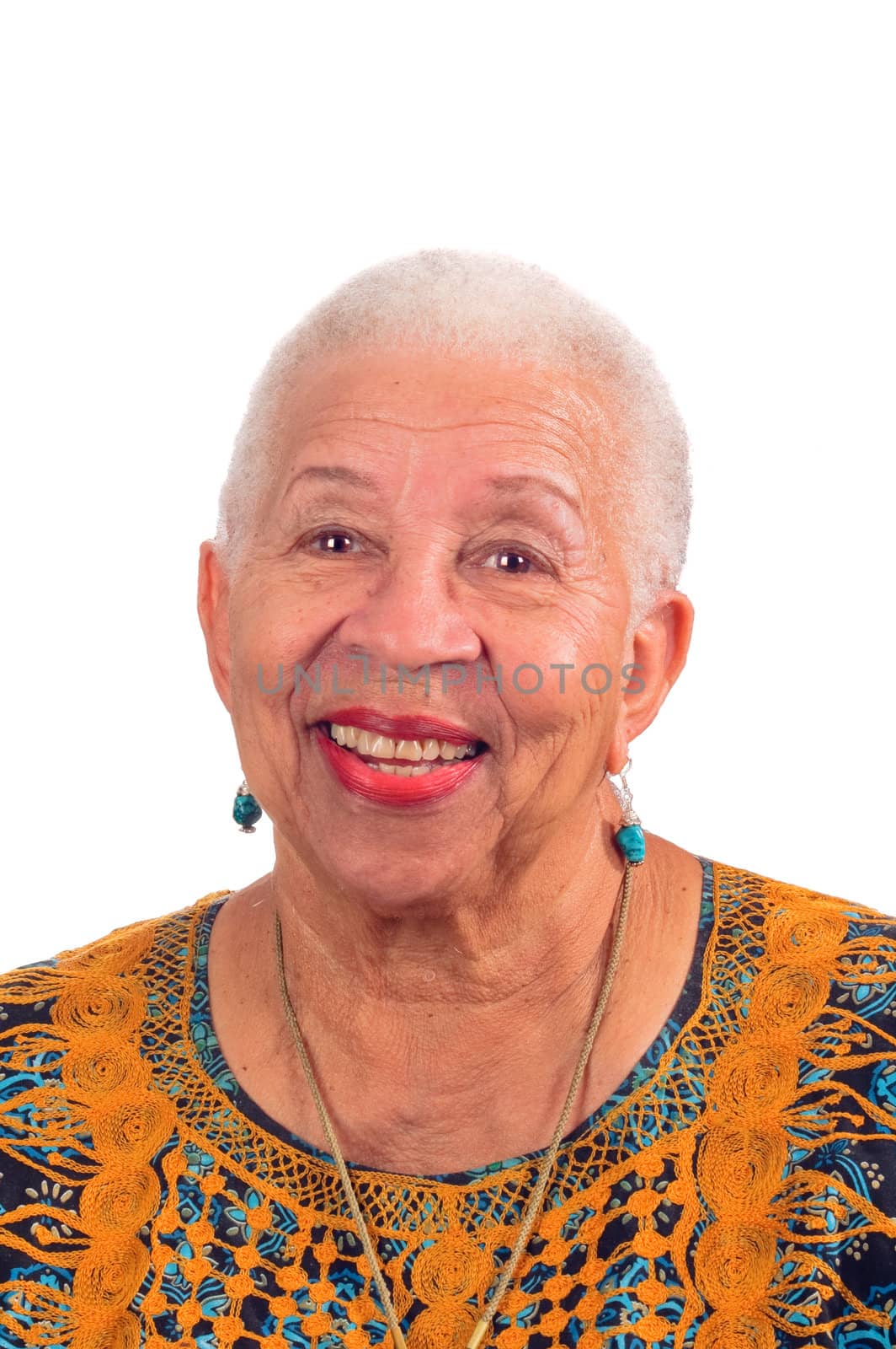 Elderly African American woman smiling from a pleasant surprise