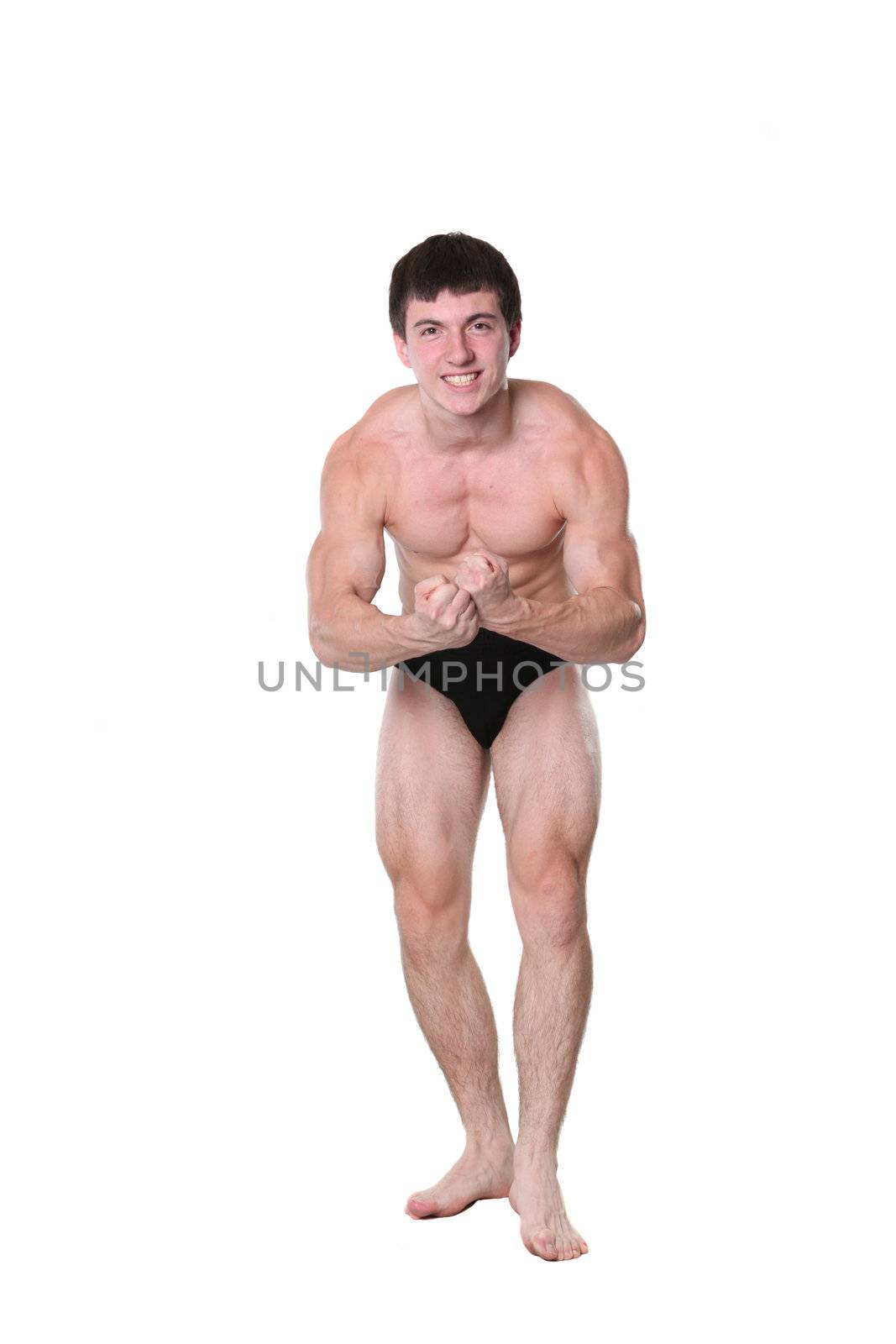 The young athlete the man poses on a white background