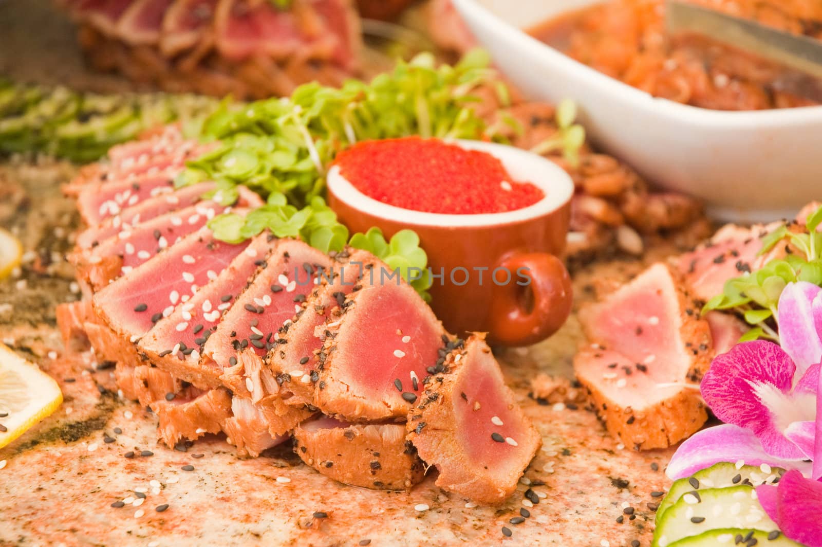 seared ahi tuna with tobiko roe on a granite table