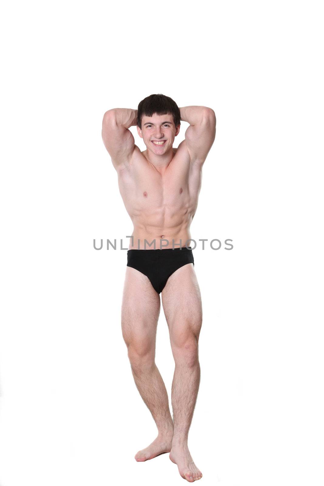 The young athlete the man poses on a white background