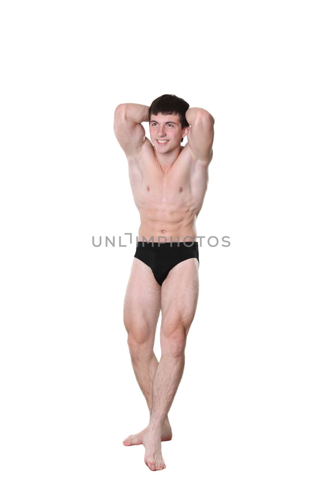 The young athlete the man poses on a white background