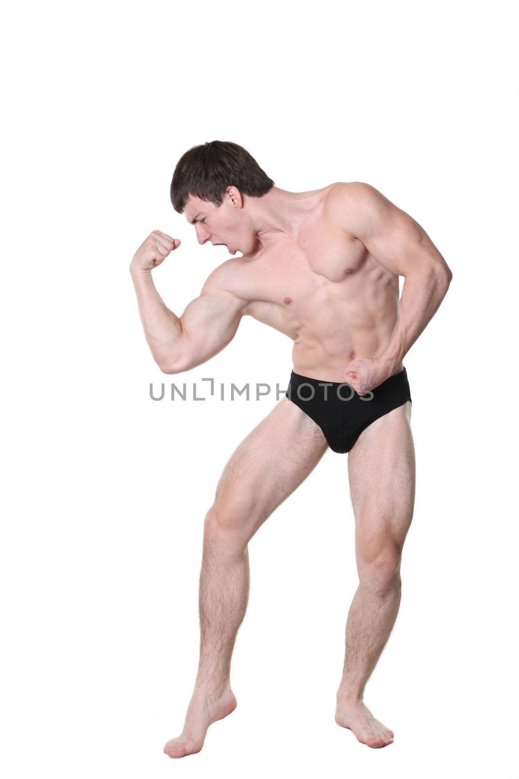 The young athlete the man poses on a white background