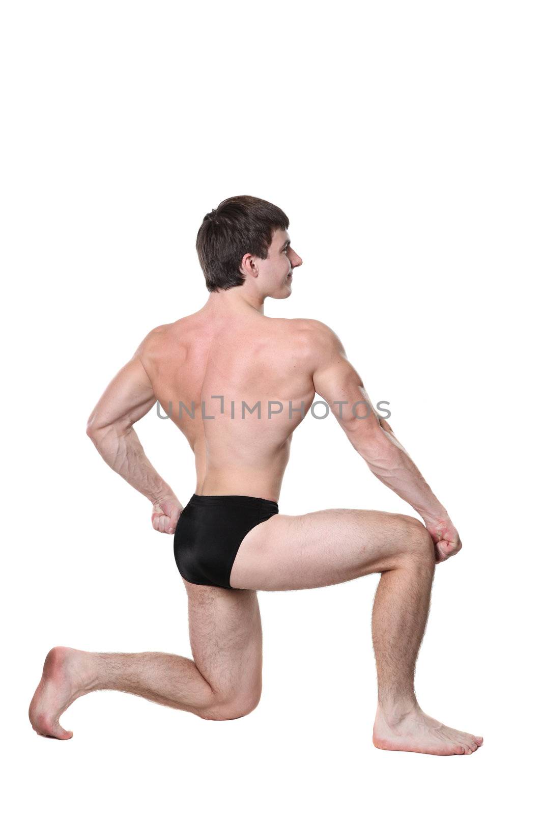 The young body builder poses with greater muscles on a white background