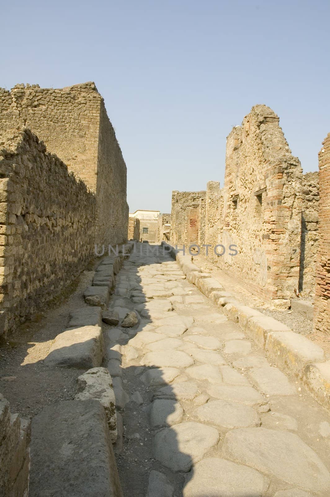 Narrow cobblestone street in the city of Pompeii