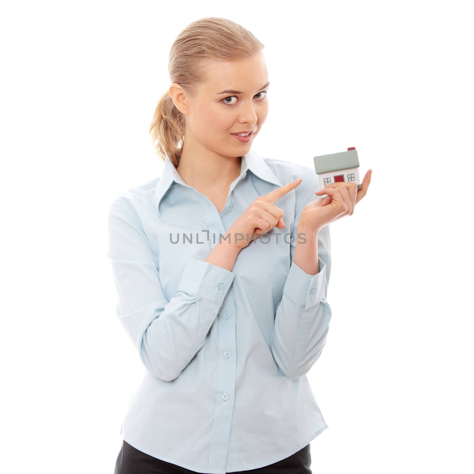 Young businesswoman holding house model, isolated on white background