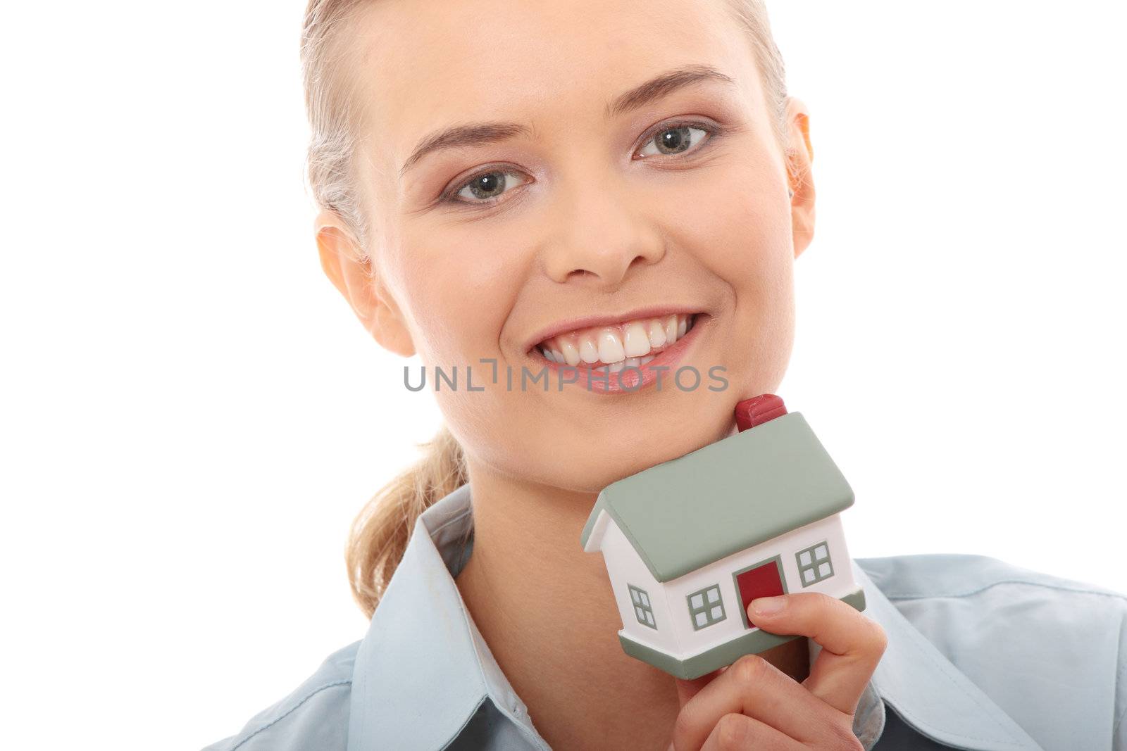 Young beautiful business woman with house model - real estate