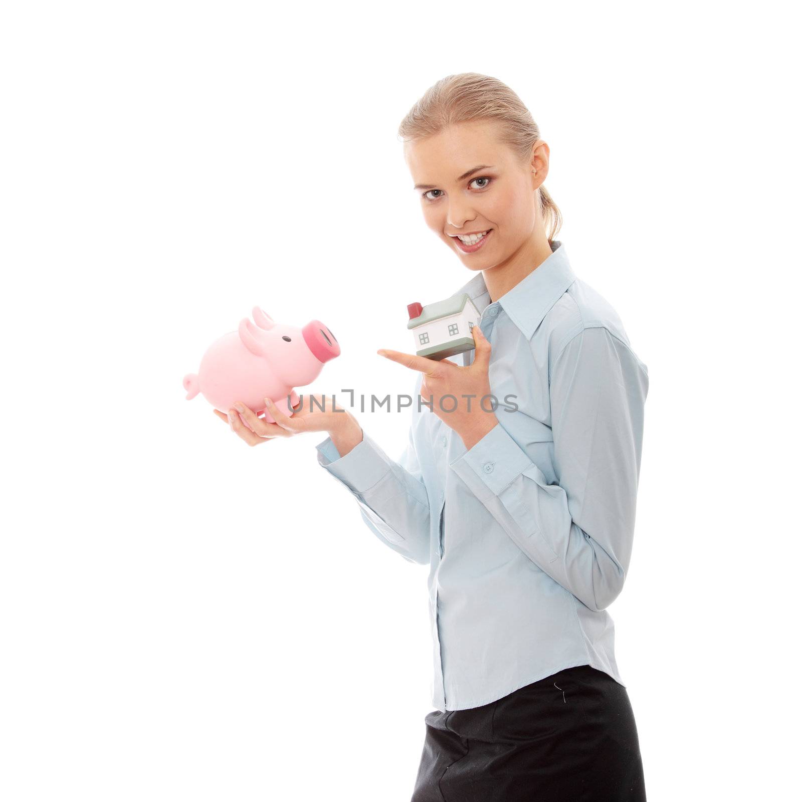 Young beautiful business woman with house model and piggy bank in hands, isolated on white background