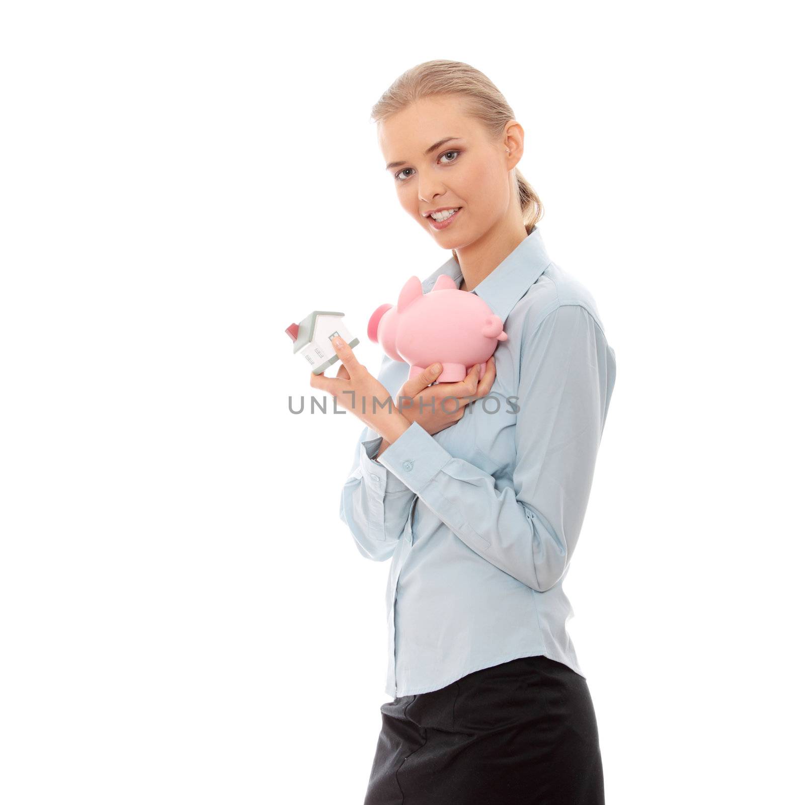 Young beautiful business woman with house model and piggy bank in hands, isolated on white background