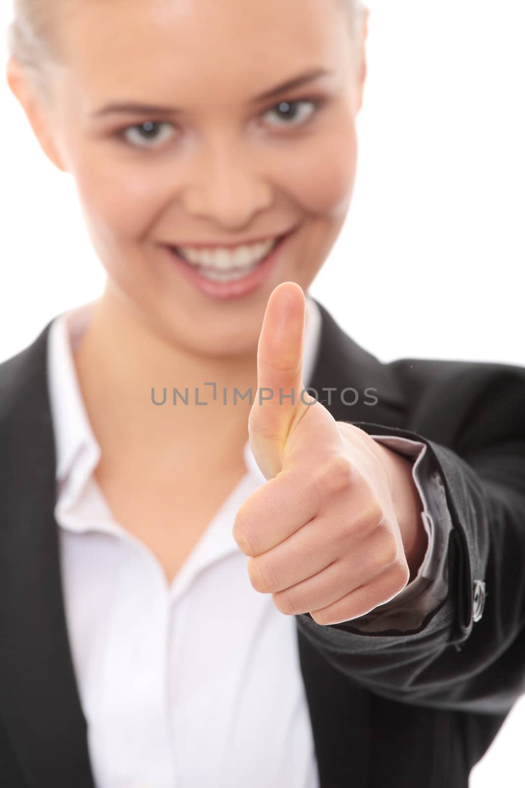 Young business woman showing OK sign, looking at camera and smiling. Isolated on white background. Focus on hand