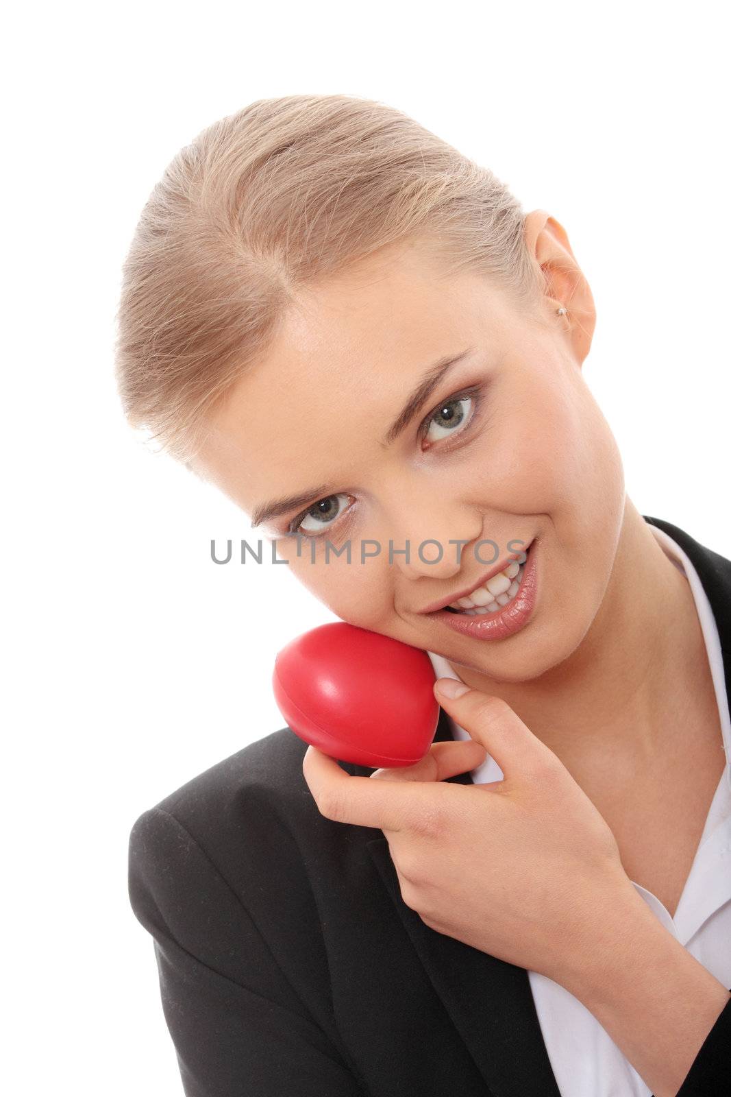 Young business woman holding heart shaped toy