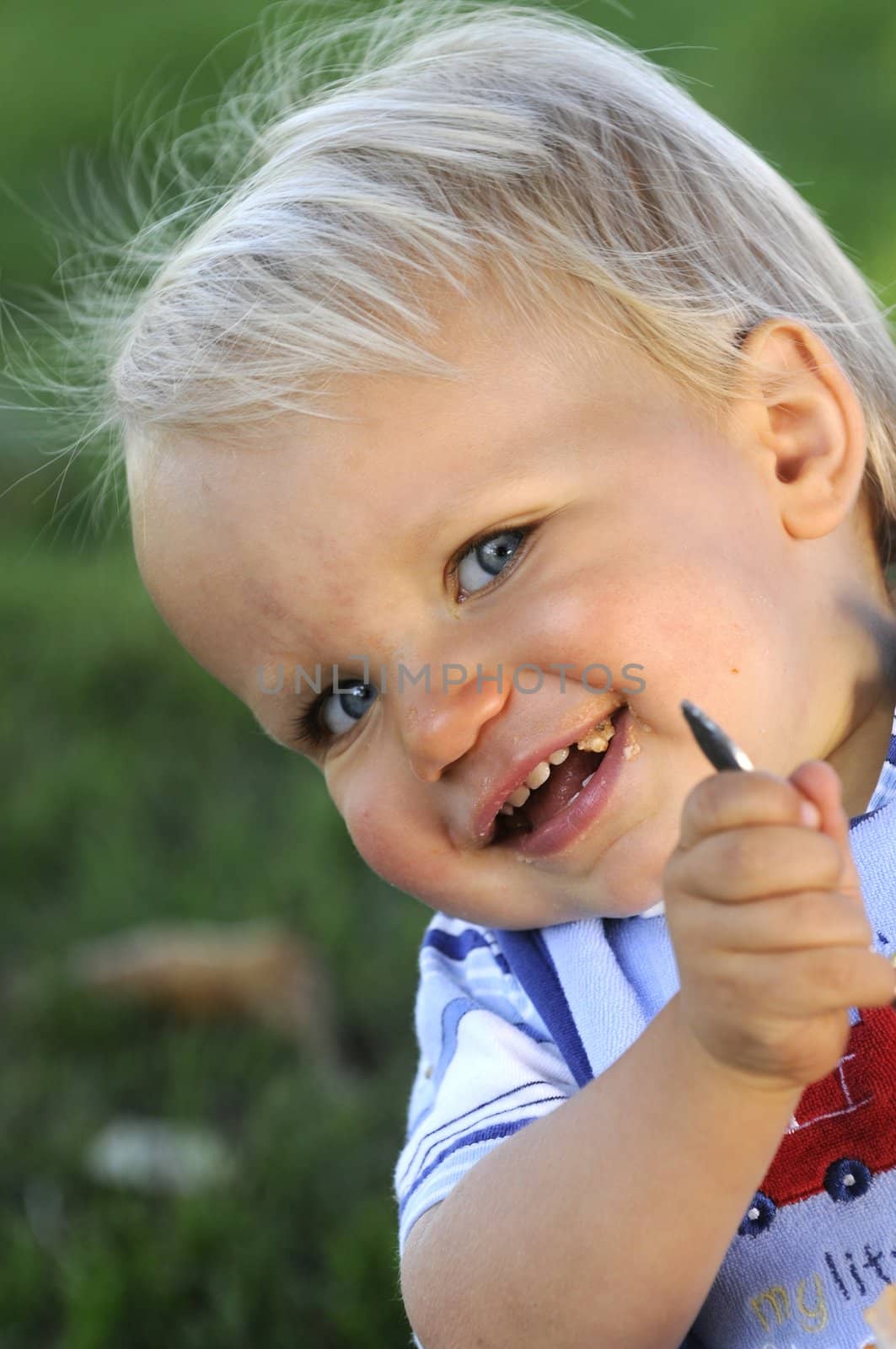 smiling Infant playing peekaboo with the viewer