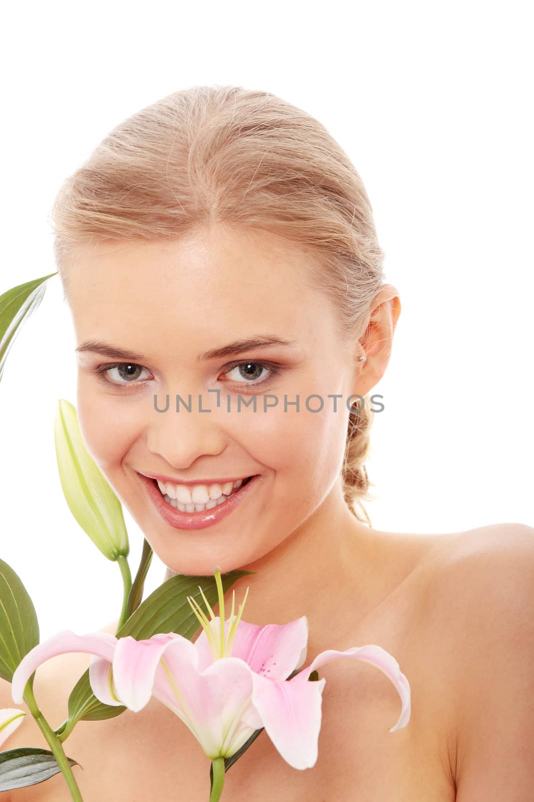Portrait of the attractive girl without a make-up, with lily flower in hand, isolated on white background