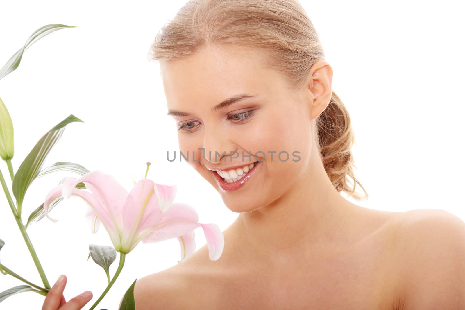 Portrait of the attractive girl without a make-up, with lily flower in hand, isolated on white background