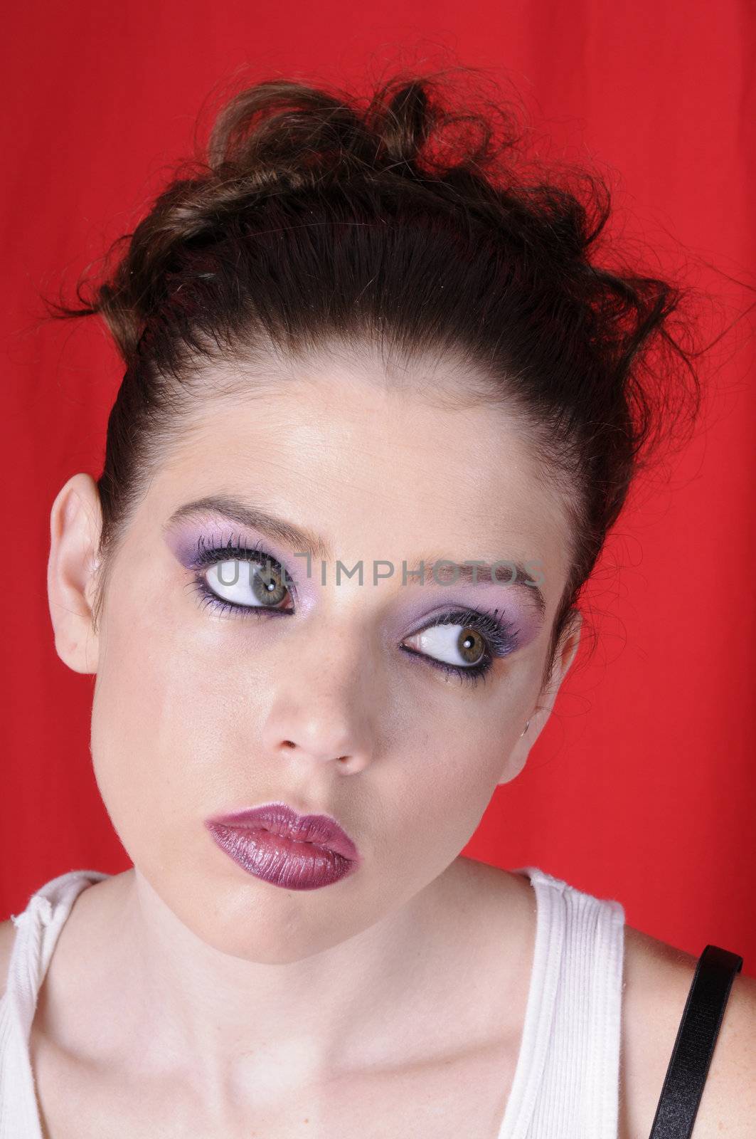 Beautiful young brunette woman in closeup over a red background