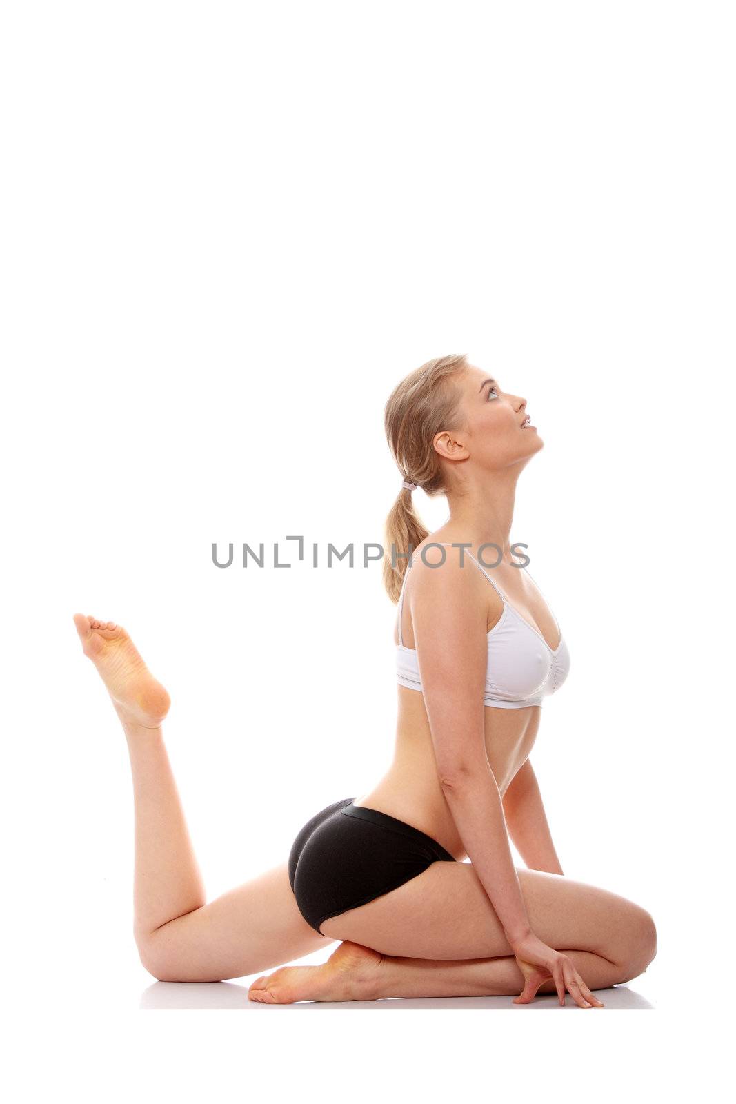 Young woman doing yoga exercise, isolated on white background