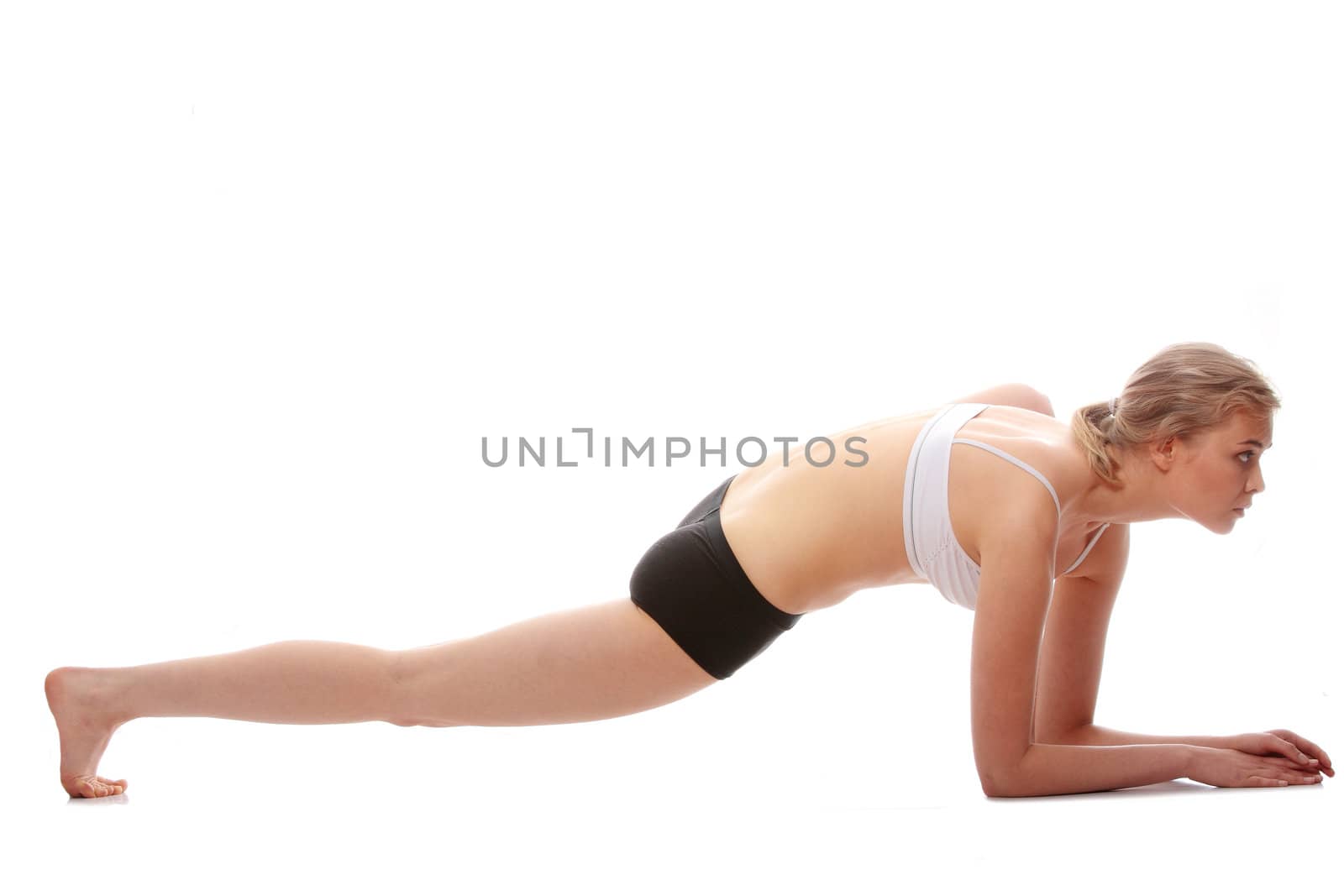 Young woman doing yoga exercise, isolated on white background