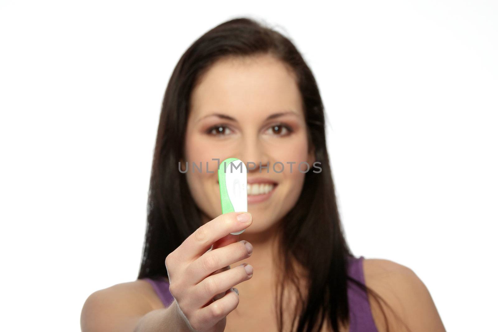 Smiling woman holding a pregnancy test, isolated on white - focuse on test