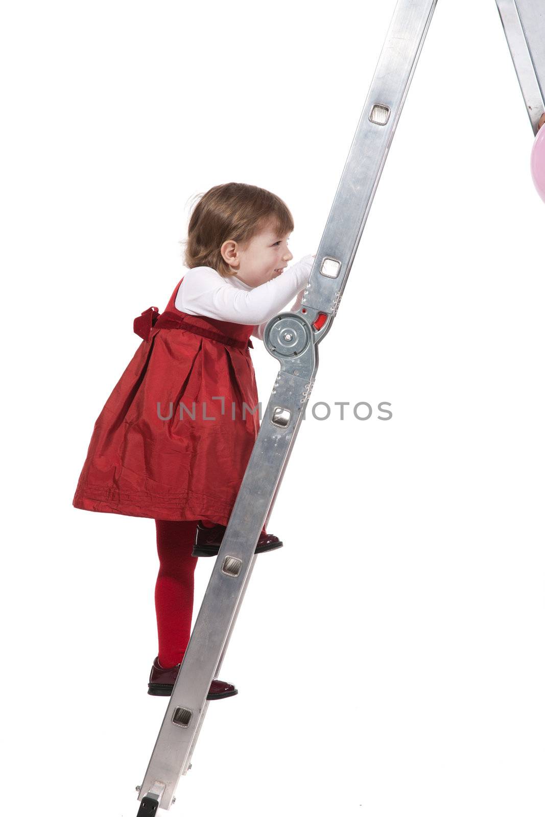 Girl climbing on the  ladder - studio shot over white