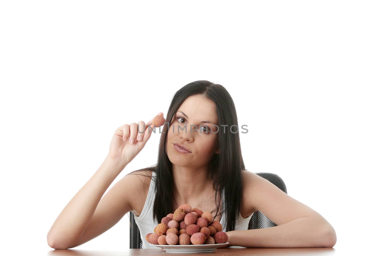 Young beautiful caucasian woman eating litchi fruits, isolated on whiet background