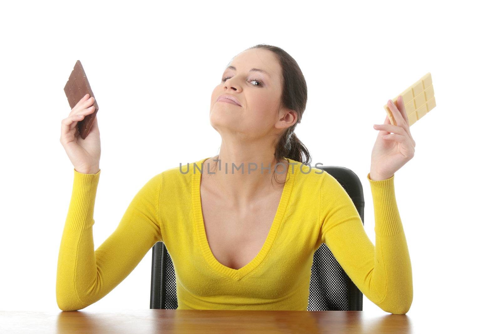 Portrait of young happy smiling woman eating dark and white chocolate