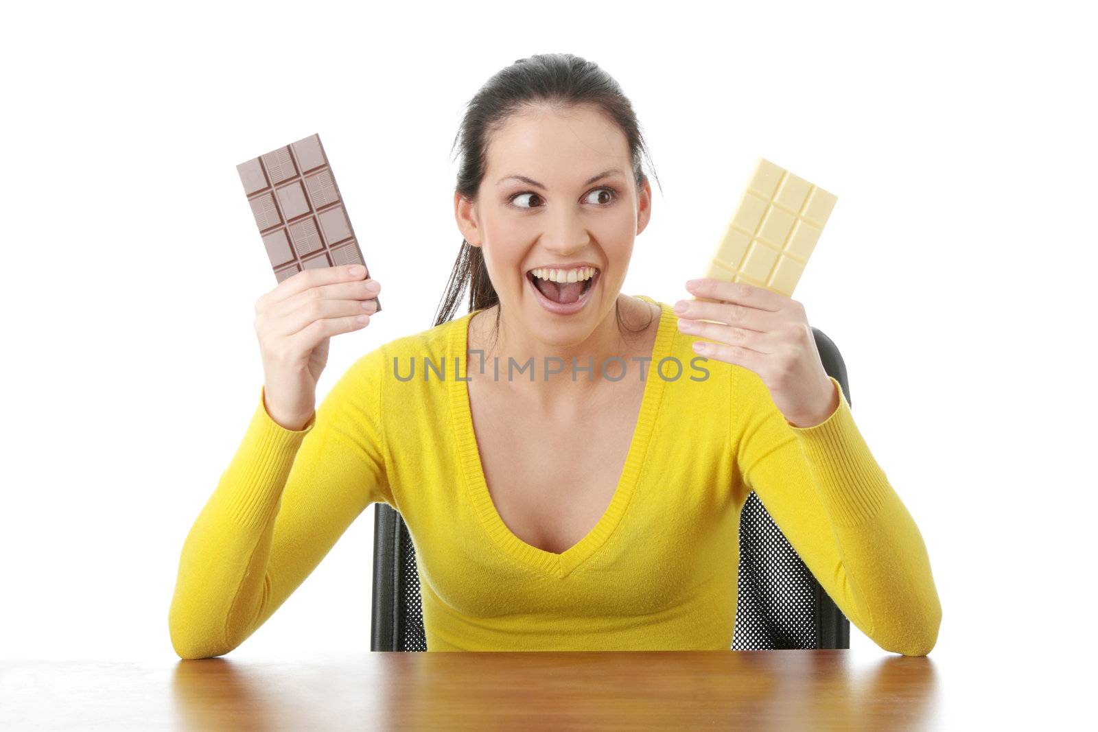 Portrait of young happy smiling woman eating dark and white chocolate