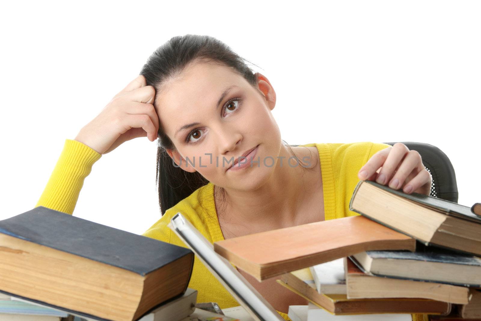 Young woman sitting behind books