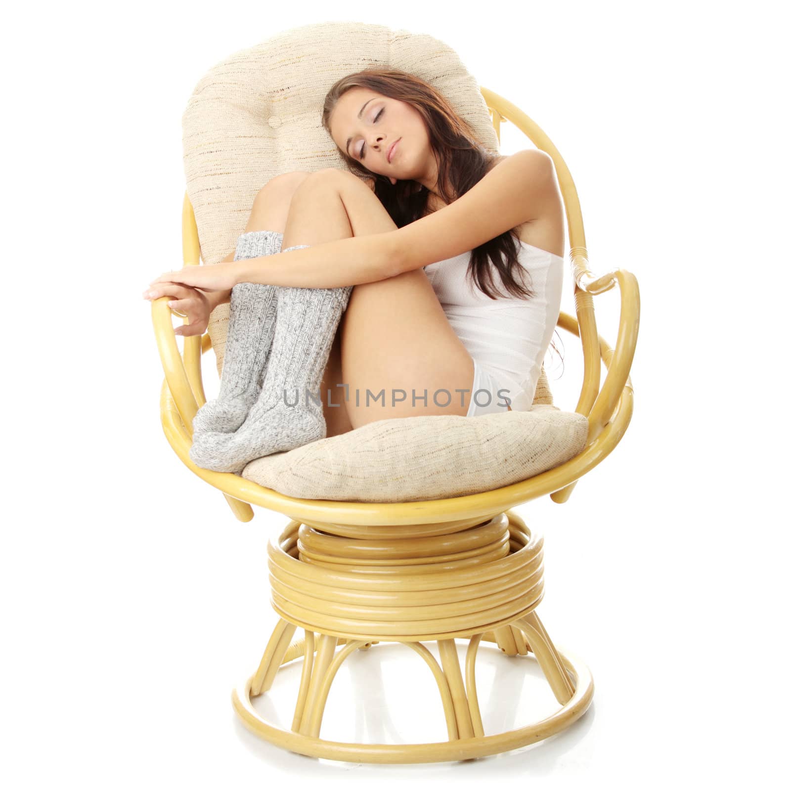 Beautiful young woman resting in armchair. Isolated on white background