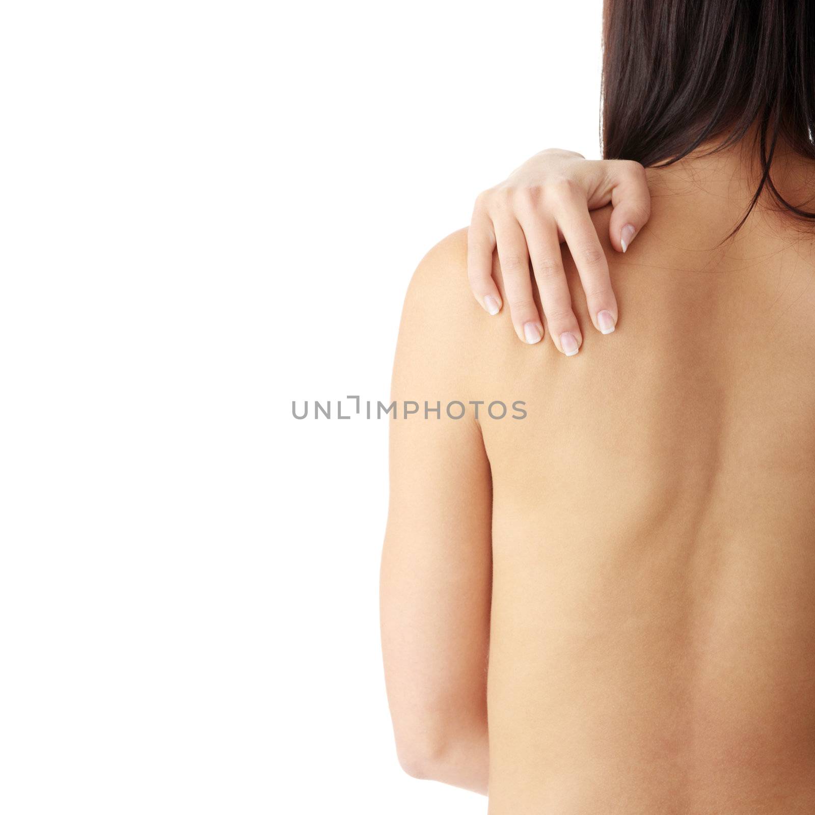 Nude woman from behind. Back pain concept. Isolated