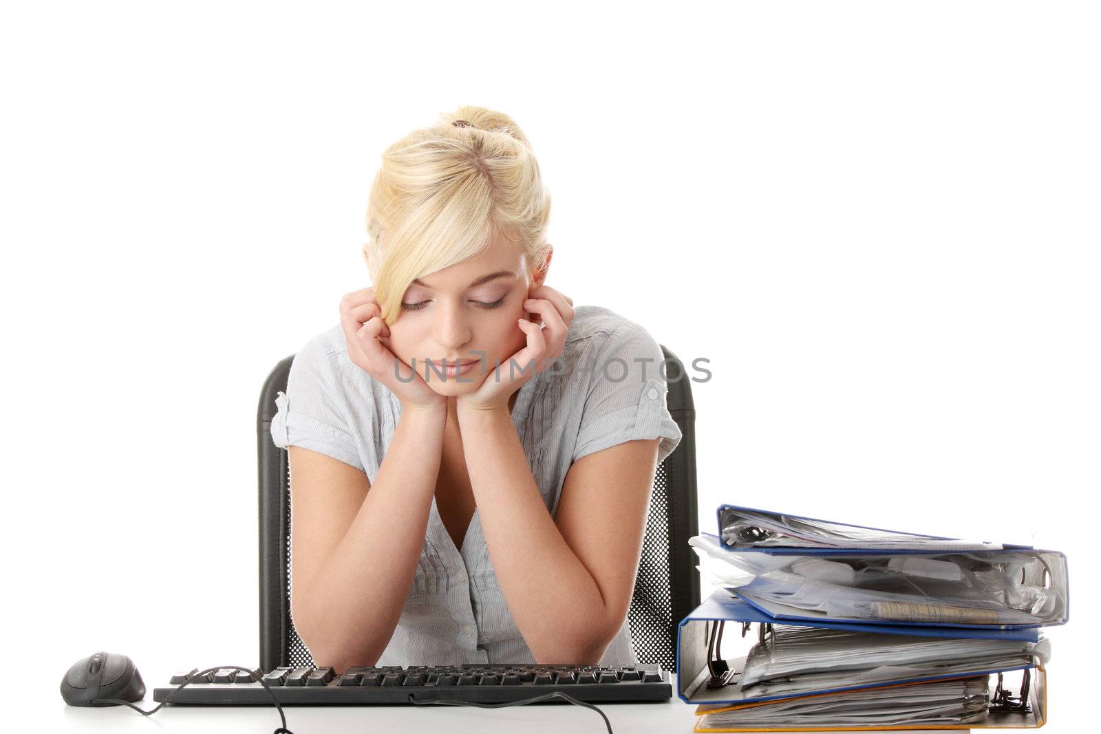 Female executive filling out tax forms while sitting at her desk. Isolated
