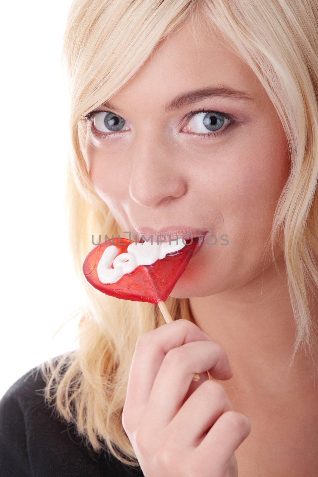 Teenage girl holding red heart shaped lollipop isolated