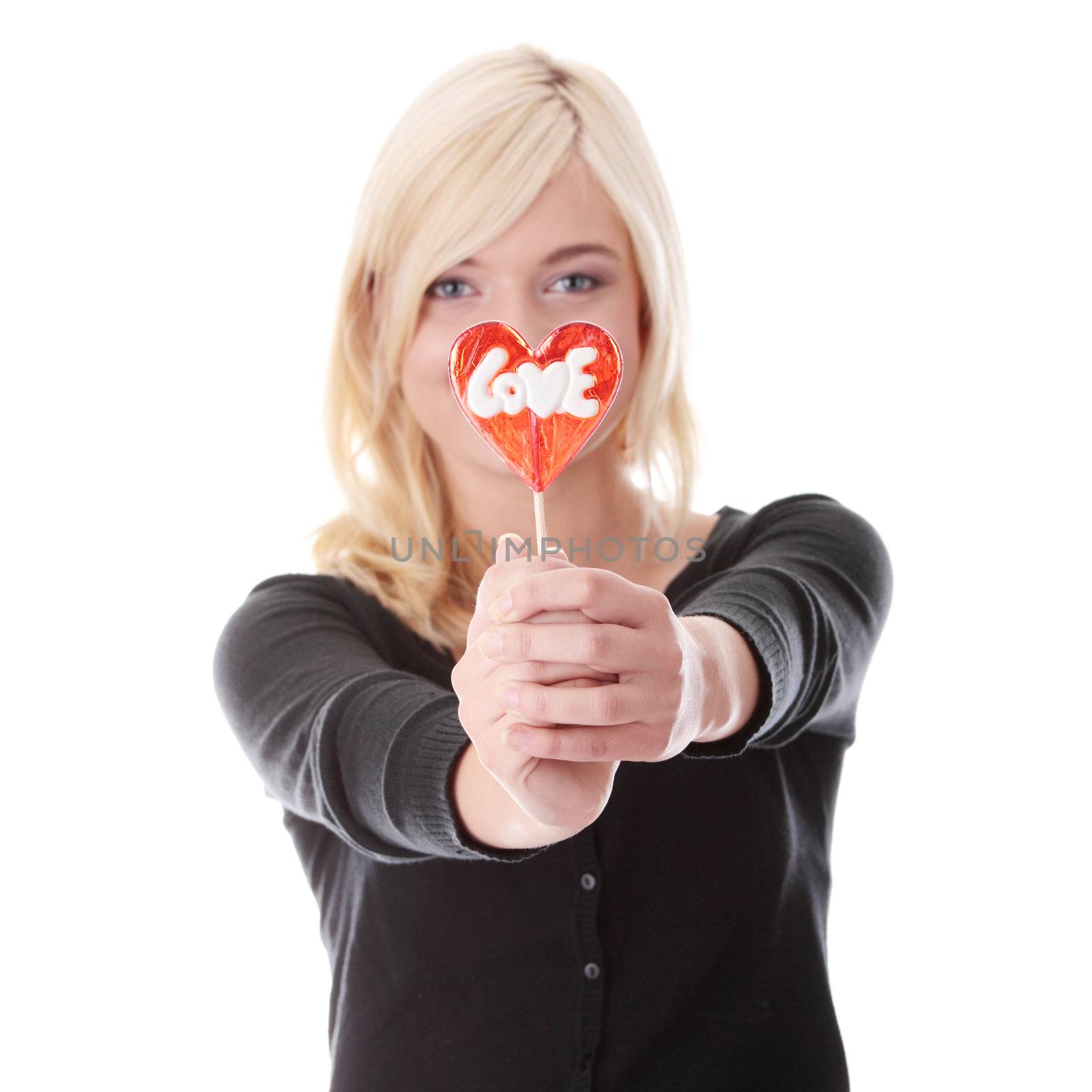 Teenage girl holding red heart shaped lollipop by BDS
