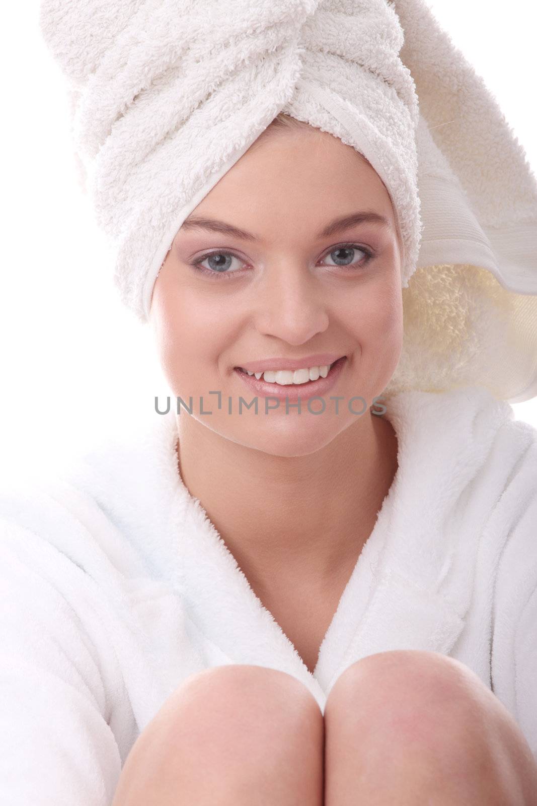 Portrait of young beautiful woman wearing bathrobe, isolated on white