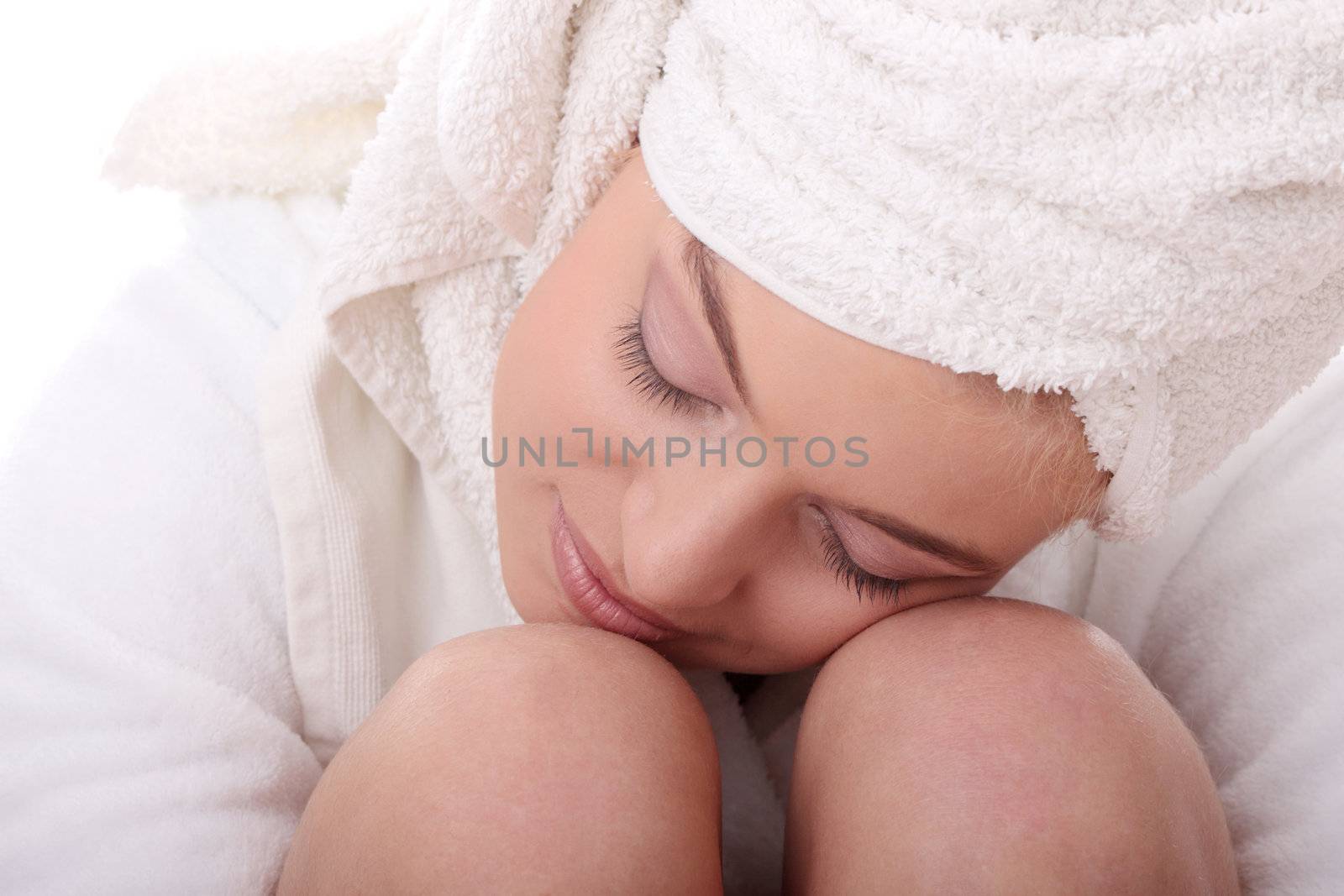 Portrait of young beautiful woman wearing bathrobe, isolated on white