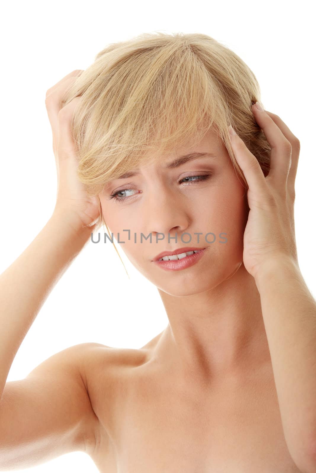 Woman with headache holding her hands to the head, isolated on white